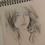 womans face sketch on white paper
